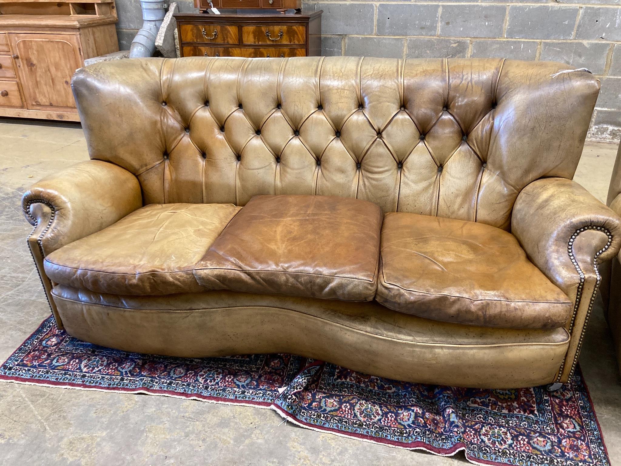 A three-seater Chesterfield leather settee, length 180cm, depth 100cm, height 84cm and a matching armchair